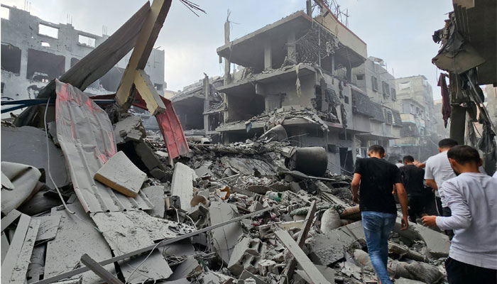 Palestinians gather at the site of Israeli strikes on houses, as the conflict between Israel and Palestine continues, in the northern Gaza Strip on October 23, 2023. — Reuters