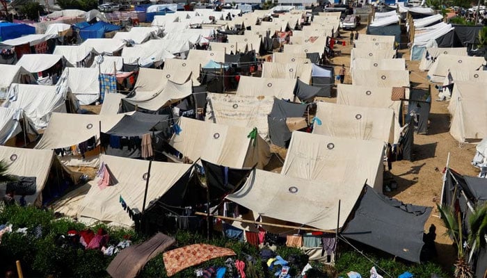 Palestinians, who fled their houses amid Israeli strikes, take shelter in a tent camp at a United Nations-run centre in Khan Younis in the southern Gaza Strip, October 23.—Reuters