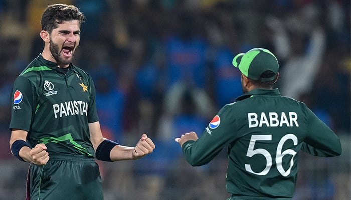 Pakistans Shaheen Shah Afridi celebrates with his captain Babar Azam (R) after taking the wicket of Afghanistan´s Rahmanullah Gurbaz during the 2023 ICC Men´s Cricket World Cup one-day international (ODI) match between Pakistan and Afghanistan at the MA Chidambaram Stadium in Chennai on October 23, 2023. — AFP