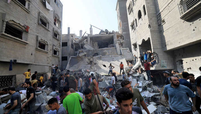 Palestinians look for survivors amid the rubble of a building hit in an Israeli air strike in Khan Yunis on the southern Gaza Strip on October 24, 2023. — AFP