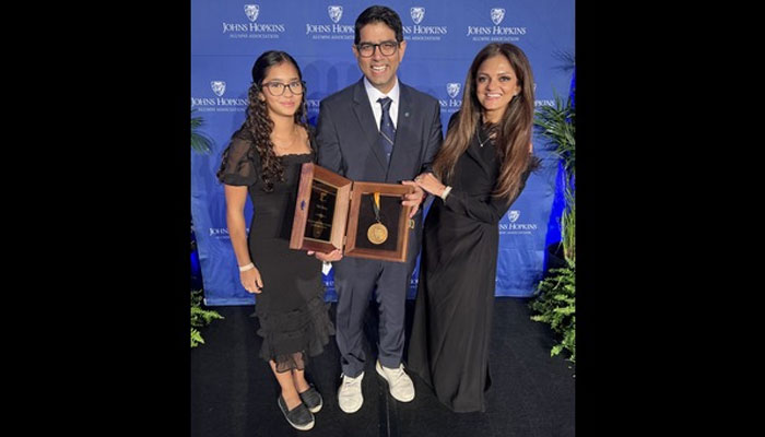 Aga Khan University (AKU) Medical College Dean Dr Adil Haider poses with family after being honoured the award. — AKU