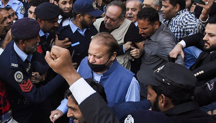 Former prime minister Nawaz Sharif walks with party workers and police officers as he leaves after appearing at the Islamabad High Court, in Islamabad, October 24, 2023. — Reuters