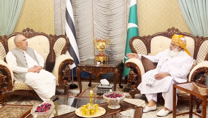 PTIs senior leader Asad Qaiser (left) during the meeting withJUI-F chief Maulana Fazlur Rehman in Islamabad, on October 26, 2023, in this still taken from a video. — X/juipakofficial