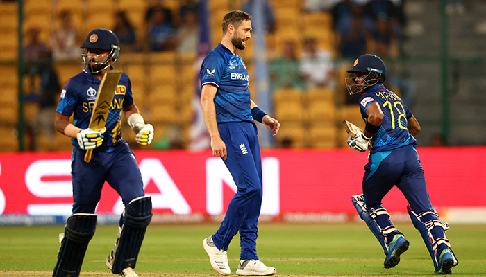 Englands Chris Woakes (centre) looks as Sri Lankas Pathum Nissanka and Sadeera Samarawickrama take runs at M. Chinnaswamy Stadium, Bengaluru, India. — Reuters