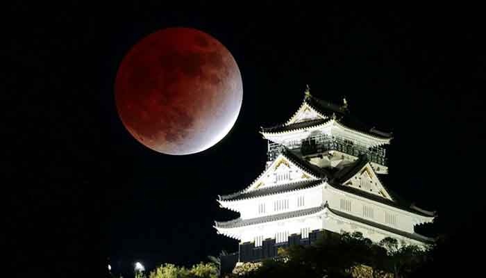 A partial lunar eclipse is observed over Gifu Castle in central Japan. — Reuters/file