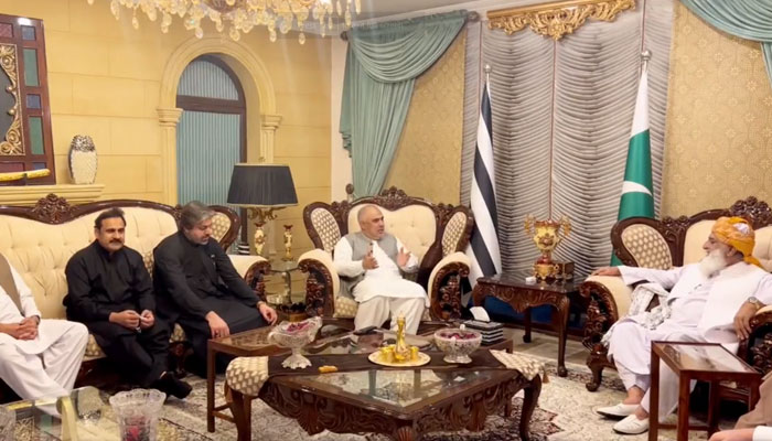 PTIs senior leadership meets JUI-F chief Maulana Fazlur Rehman (right) in Islamabad, on October 26, 2023, in this still taken from a video. — X/ juipakofficial