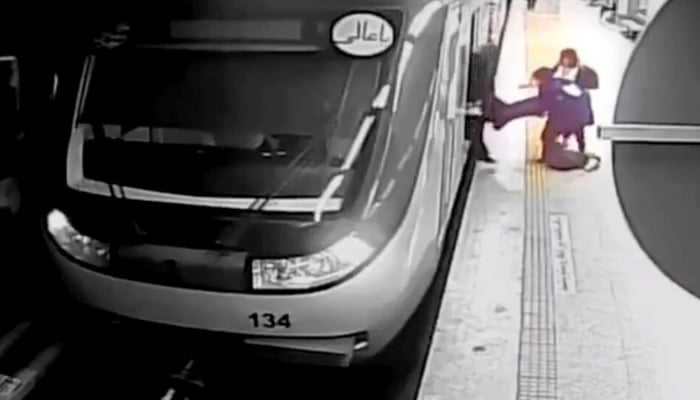 In this image from a surveillance video aired by Iranian state television, women pull 17-year-old Armita Garawand from a train car on the Tehran Metro in Tehran, Iran on October 1, 2023. — AFP