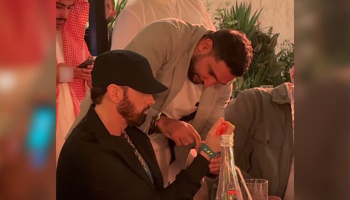 Amir Khan wraps watchs band around Eminems hand in this still taken from a video. — Instagram/@amirkingkhan