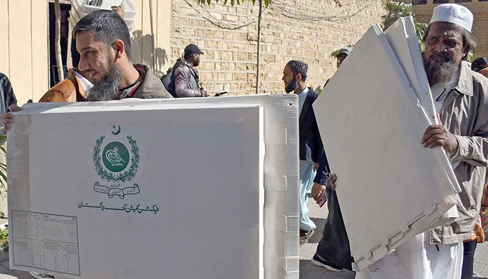 People carrying electoral material on the eve of local government elections in Karachi, on January 14, 2023. — Online