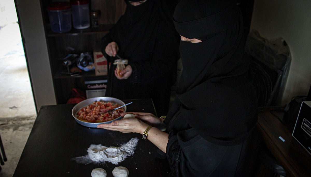 Wajihas mother, Masooma, prepares dough for Afghan snack Bolani. — Hassaan Ahmed