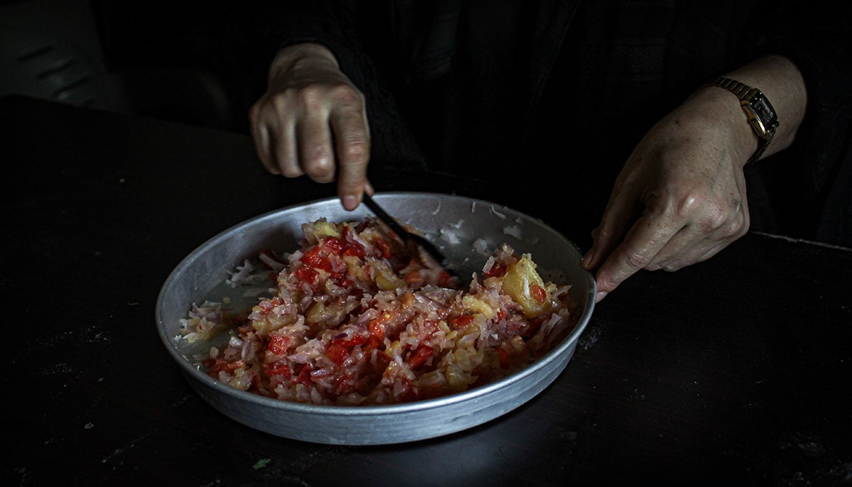 Masooma prepares filling for Afghan snack Bolani. — Hassaan Ahmed