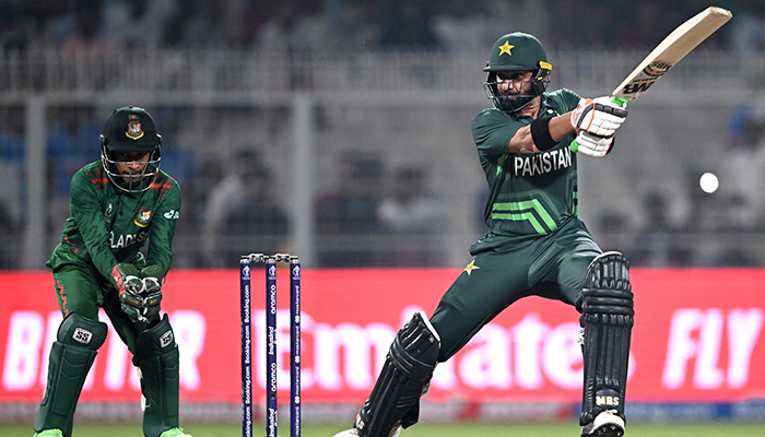 Pakistans Iftikhar Ahmed (right) plays a shot as Bangladeshs wicketkeeper Mushfiqur Rahim watches during a World Cup match between Pakistan and Bangladesh at the Eden Gardens in Kolkata on October 31, 2023. — AFP