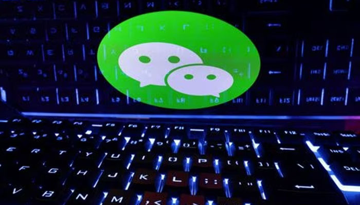 A keyboard is placed in front of a displayed WeChat logo in this illustration taken February 21, 2023.—Reuters