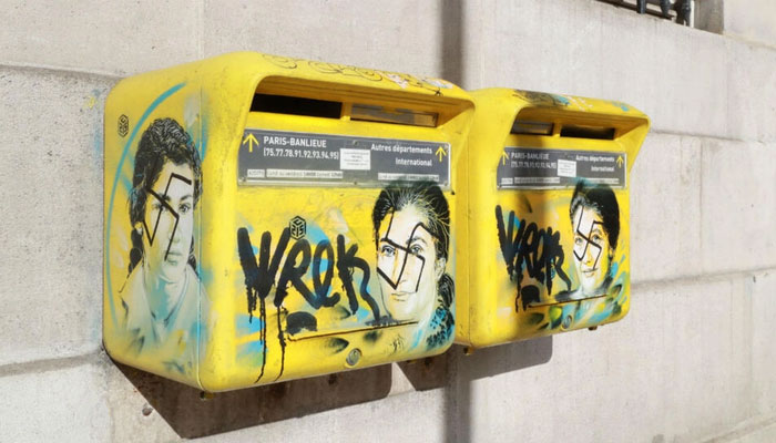 A photo taken on February 11, 2019 in Paris shows anti-Semitic graffiti written on letter boxes displaying a portrait of late Holocaust survivor Simone Veil.—AFP