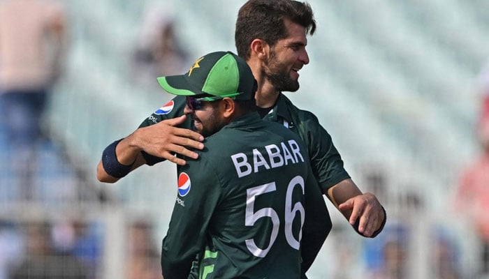 Skipper Babar Azam and fast bowler Shaheen Shah Afridi celebrate the pacers record in a match against Bangladesh.  x/iShaheeenAfridi