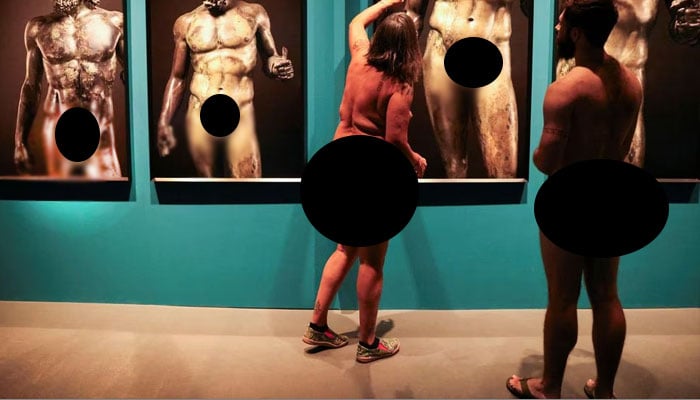 Guide Edgard Mestre talks with Marta, 59, as they take part in a nudist visit to the Archaeology Museum of Catalonia about The Bronzes of Race exhibition of Luigi Spina’s photographs depicting two large Greek bronze statues of naked in Barcelona, Spain October 28, 2023 — Reuters