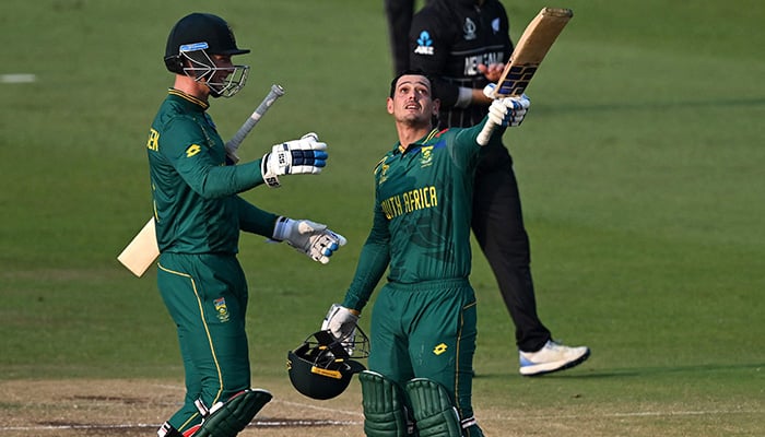 South Africa's Quinton de Kock (R) celebrates with teammate Rassie van der Dussen after scoring a century (100 runs) during the ICC Men's Cricket World Cup 2023 one-day international match between New Zealand and South Africa at the Maharashtra Cricket Association Stadium in Pune on November 1, 2023. — AFP