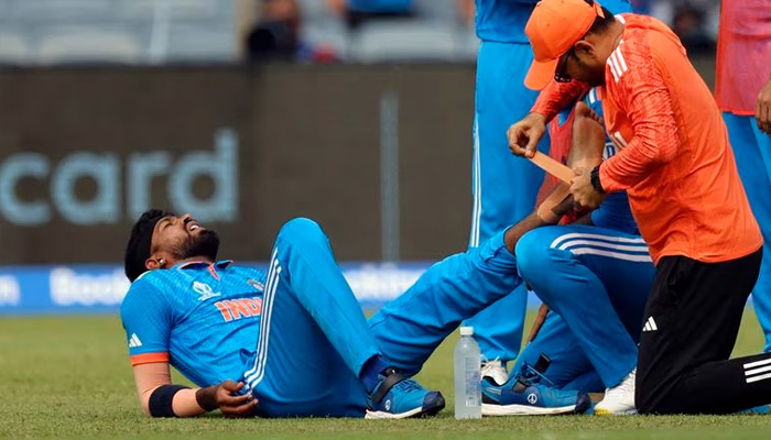 Indias Hardik Pandya receives medical attention after sustaining an injury during match against Bangladesh in Maharashtra Cricket Association Stadium, Pune, India on October 19, 2023. — AFP