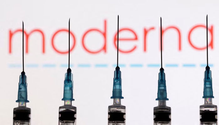 Syringes with needles are seen in front of a displayed Moderna logo in this illustration taken, on November 27, 2021. — Reuters