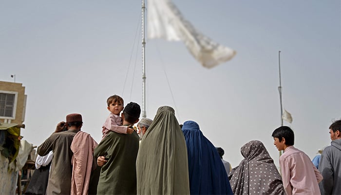 In this photo taken on November 1, 2023, Afghan refugees leave a registration centre upon their arrival from Pakistan, at the Afghanistan-Pakistan border in the Spin Boldak district of Kandahar province. — AFP