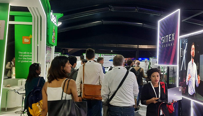 Attendees walk through stalls at the Gitex Global. — Photo by author