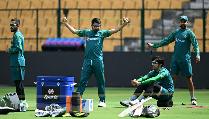 Pakistans cricketers warm up during a practice session at the M. Chinnaswamy Stadium in Bengaluru on November 3, 2023, ahead of the 2023 ICC Mens Cricket World Cup one-day international (ODI) match between Pakistan and New Zealand. — AFP