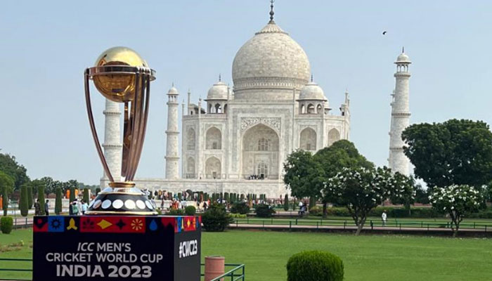 A photograph of the ICC World Cup 2023 trophy with the Taj Mahal in the background. — ICC