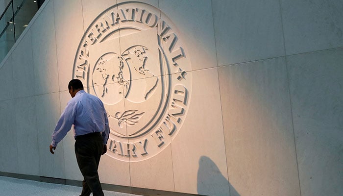 A man walks past the logo of the International Monetary Fund (IMF) at its headquarters in Washington, U.S., May 10, 2018. — Reuters