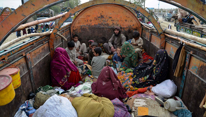 Afghan refugees with their belongings arrive on trucks from Pakistan, at a registration centre near the Afghanistan-Pakistan border in the Spin Boldak district of Kandahar province on November 6, 2023. — AFP