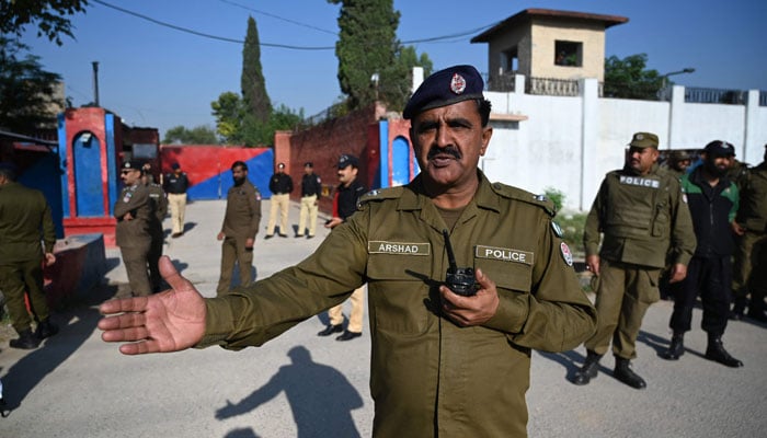 Police officials stand guard outside the Adiala Jail during the hearing of jailed former Pakistan prime minister Imran Khan, in Rawalpindi on October 23, 2023. — AFP