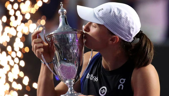 Polands Iga Swiatek celebrates with the trophy after winning her Womens Tennis Association (WTA) Final match against Jessica Pegula of the US in Cancun, Mexico on November 6, 2023. — Reuters
