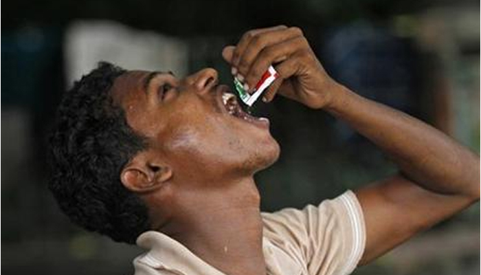 A man eats gutka along a street in Kolkata, India on August 23, 2012. — Reuters