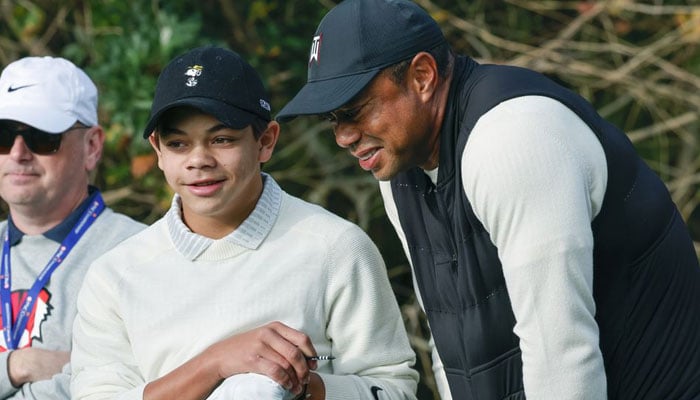 Charlie Woods (left) and Tiger Woods talk on the first tee box before the first hole during a pro-am round of the PNC Championship golf tournament at Ritz Carlton Golf Club Grande Lakes Orlando Course. —Reuters