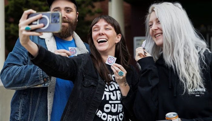 Voters take a selfie at a polling location as voters in Ohio decide whether to enshrine abortion protections into the state constitution, in Columbus, Ohio, US November 7, 2023.—Reuters