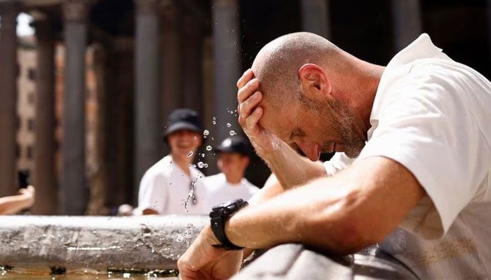 A man cools off at a fountain near the Pantheon, after giving up queuing to enter because it is too hot and the queue is too long, during a heatwave across Italy as temperatures are expected to cool off in the Italian capital, in Rome, Italy July 19, 2023. — Reuters