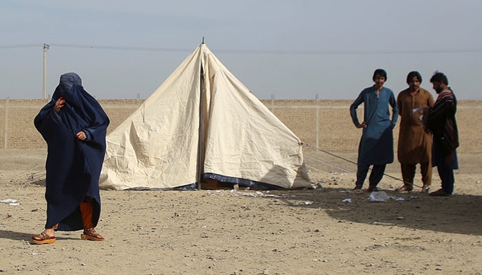 An Afghan woman in a burqa stands near a tent, as she heads back to Afghanistan, after Pakistan gave a final warning to undocumented immigrants to leave, at the Friendship Gate of Chaman Border Crossing along the Pakistan-Afghanistan Border in Balochistan Province, in Chaman, Pakistan November 4, 2023. — Reuters