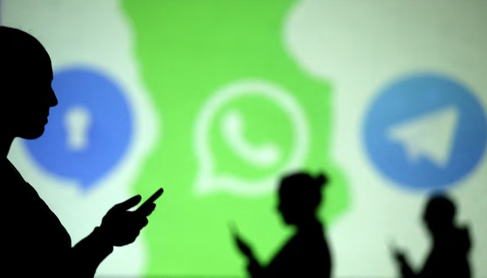 Silhouettes of mobile users are seen next to logos of social media apps Signal, Whatsapp and Telegram projected on a screen in this picture illustration taken March 28, 2018. — Reuters