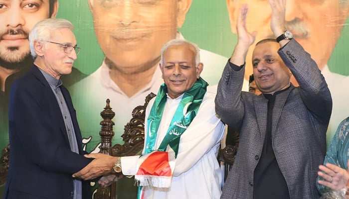 IPP leaders Jahangir Tareen (left) and Aleem Khan (right) welcome Ghulam Sarwar to their party ranks at a public gathering in Taxila on November 9, 2023. — X/@istehkamPK