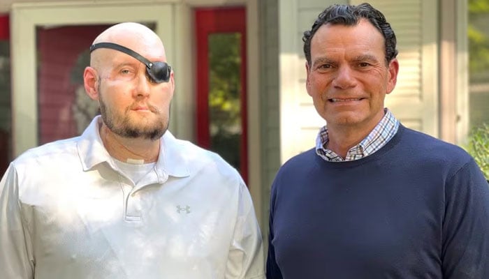 Aaron James of Hot Springs, Arkansas, poses with Dr. Eduardo D Rodriguez after he underwent surgery for the world’s first whole-eye transplant as part of a partial face transplant at NYU Langone in an undated photograph. — Reuters
