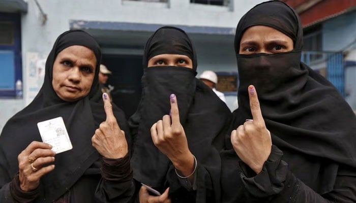 Muslim women display their inked fingers after casting their votes during the third phase of West Bengal Assembly elections in Kolkata, India, April 21, 2016. — Reuters