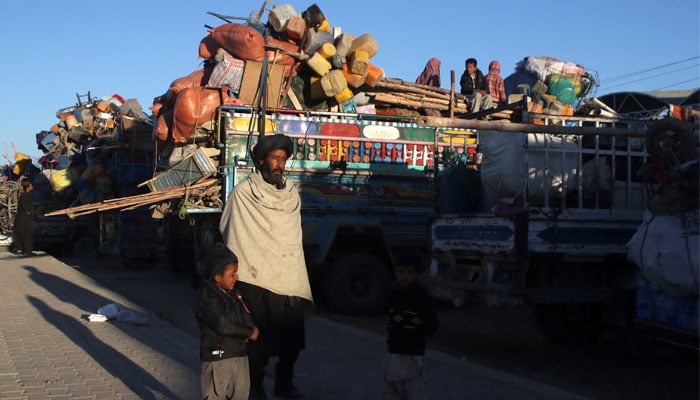 Muhammad Yaqoob, 55, an Afghan national with his children stands with trucks loaded with belongings as they head back to Afghanistan from Pakistan, at the Chaman Border Crossing along the Pakistan-Afghanistan Border in Balochistan Province, in Chaman, Pakistan November 10, 2023. — Reuters