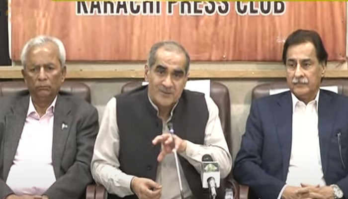 Khawaja Saad Rafique (centre) addresses a presser in Karachi on November 12, 2023, in this still taken form a video. — YouTube/Geo News Live