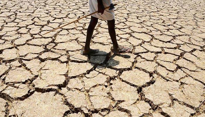 This file photograph shows a farmer posing in his dried-up field. — AFP/File