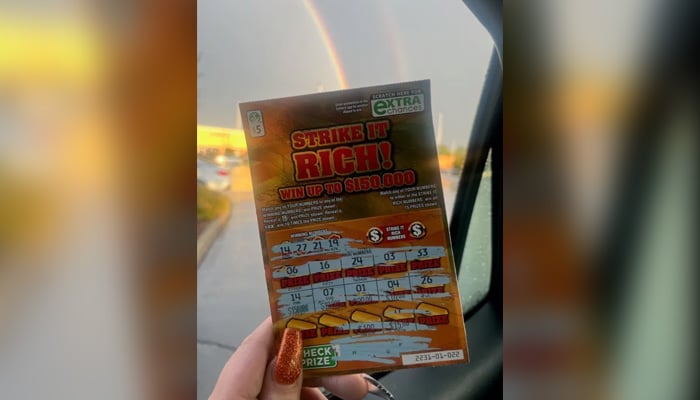 Briana Mills holds her lottery ticket. — Virginia Lottery