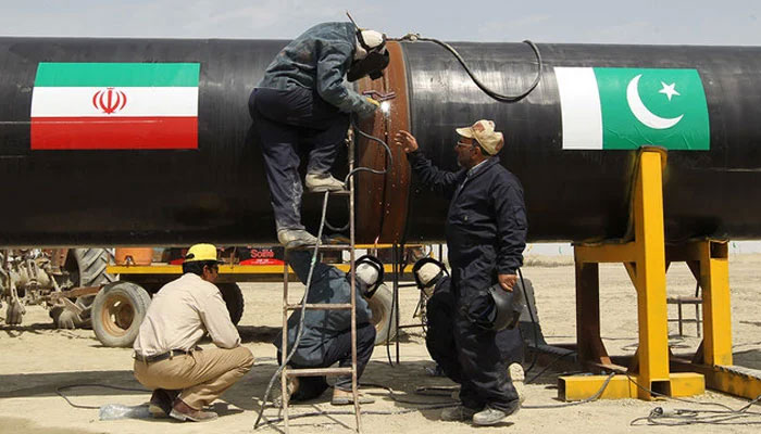 Iranians work on a section of a pipeline in the Iranian border city of Chah Bahar on March 11, 2013 . — AFP