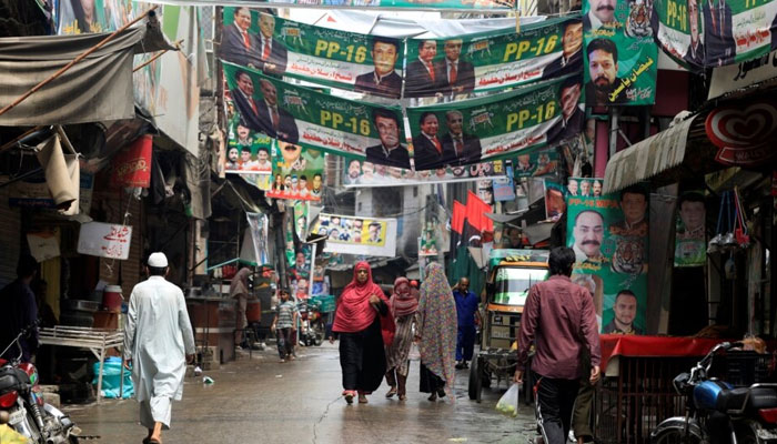 A street is decorated with the flags and banners of political parties ahead of a general election in Rawalpindi, Pakistan, July 23, 2018. — Reuters