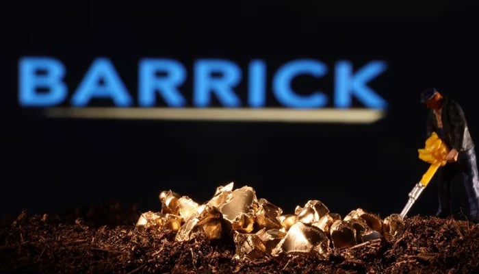A small toy figure and imitation gold are seen in front of the Barrick logo in this picture taken on Nov. 19, 2021. — Reuters