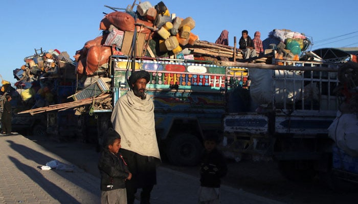 Muhammad Yaqoob, 55, an Afghan national with his children stands with trucks loaded with belongings as they head back to Afghanistan from Pakistan, at the Chaman Border Crossing along the Pakistan-Afghanistan Border in Balochistan Province, in Chaman, Pakistan November 10, 2023. — Reuters