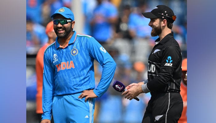 India´s captain Rohit Sharma along with his New Zealand´s counterpart Kane Williamson (R) gesture during the toss before the start of the 2023 ICC Men´s Cricket World Cup one-day international (ODI) at the Wankhede Stadium in Mumbai on November 15, 2023. — AFP