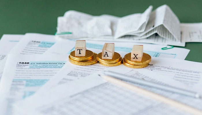 Representational image of tax Documents scattered on a table. — Pexels